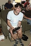 Andrew Escamilla trys on the merchandise at Swinging Saturday at Cole Haan in Easthampton on 8-14-04.  photo by Rob Rich copyright 2004 516-676-3939  robwayne1@aol.com