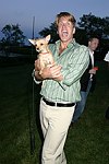 Gregg Connors with a new friend  at the God's Love We Deliver Mid Sumer Drinks party on 6-12-04 at the Southampton Estate of Don Burns and Gregg Connors  all photos by Rob Rich copyright 2004 516-676-3939