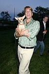 Gregg Connors with a new friend  at the God's Love We Deliver Mid Sumer Drinks party on 6-12-04 at the Southampton Estate of Don Burns and Gregg Connors  all photos by Rob Rich copyright 2004 516-676-3939