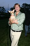 Gregg Connors with a new friend  at the God's Love We Deliver Mid Sumer Drinks party on 6-12-04 at the Southampton Estate of Don Burns and Gregg Connors  all photos by Rob Rich copyright 2004 516-676-3939