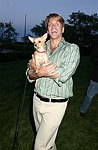 Gregg Connors with a new friend  at the God's Love We Deliver Mid Sumer Drinks party on 6-12-04 at the Southampton Estate of Don Burns and Gregg Connors  all photos by Rob Rich copyright 2004 516-676-3939